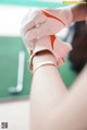 A person putting a golf glove on a woman's leg.