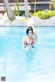 A woman in a bikini in a swimming pool.