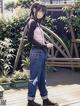 A woman standing on a wooden deck next to a fence.