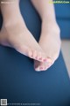 A close up of a woman's feet on a yoga mat.